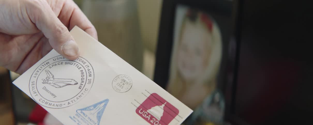 A person holds a stamped postcard