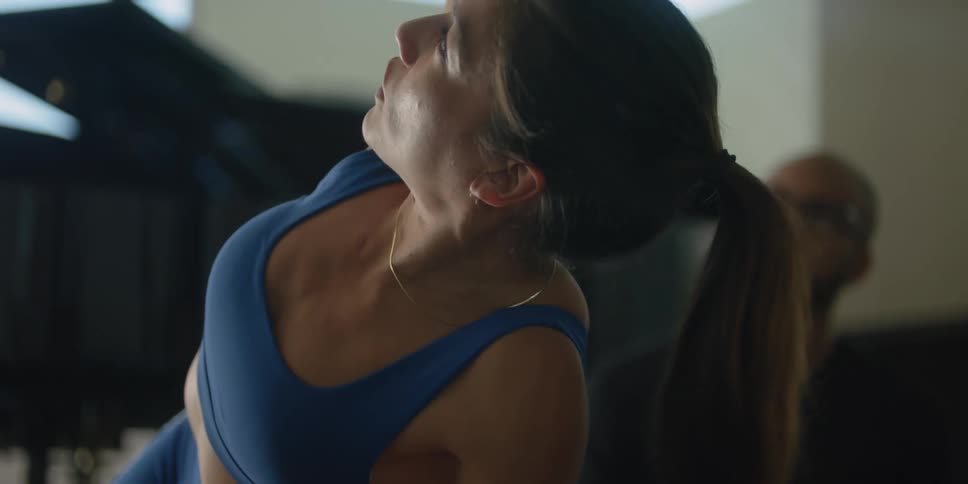 Personal trainer teaching a client how to exercise at home
