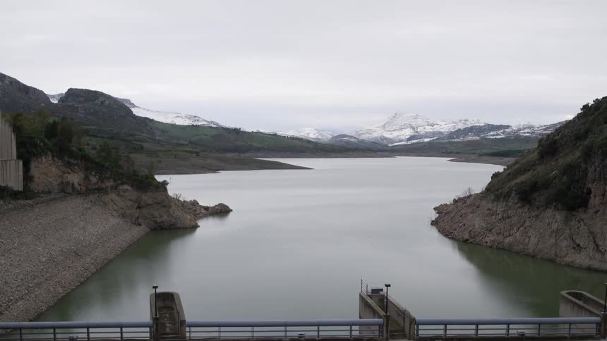 A river near a mountain on a cloudy day