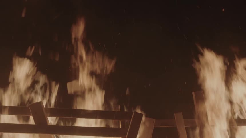 A wood slatted structure is on fire
