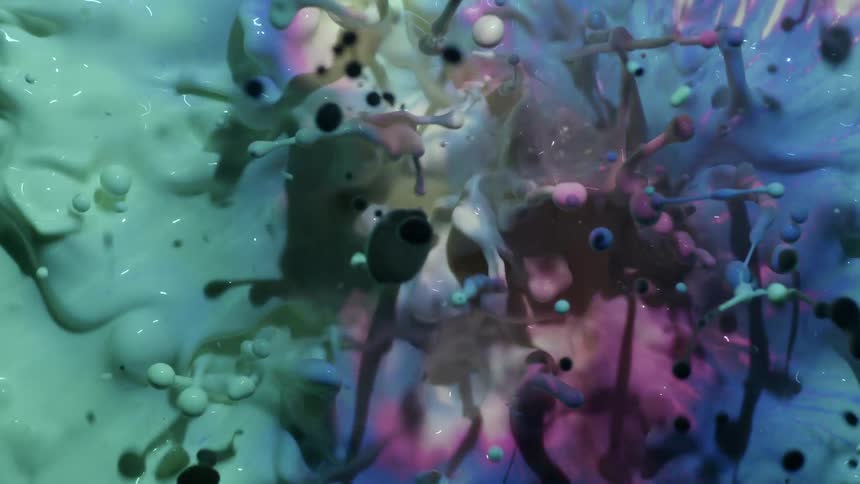 Paint colors spread and explode underwater