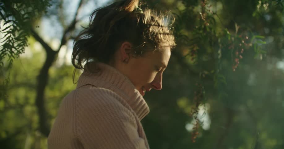 A woman pruning a tree outdoors