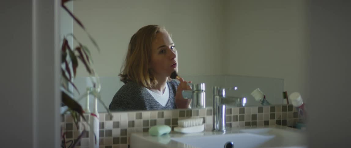 A woman putting on makeup