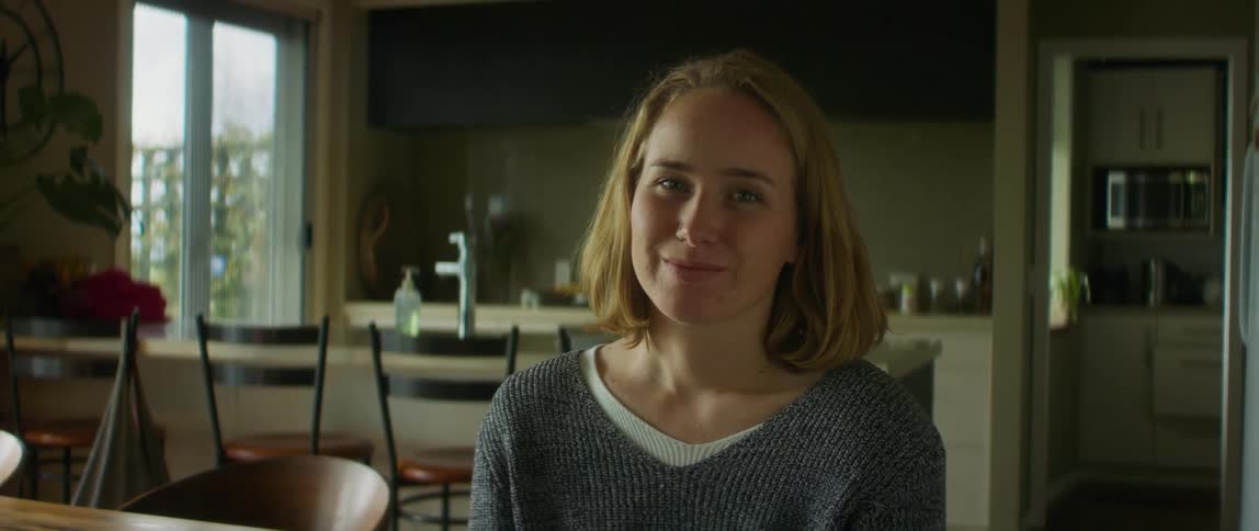 A woman at home smiles