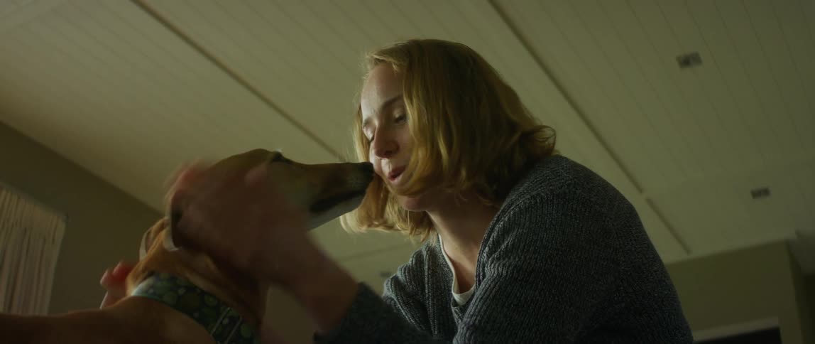 A woman pets her dog