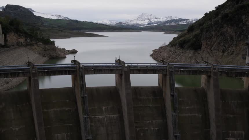 The enormous structure of a reservoir wall forming a lake