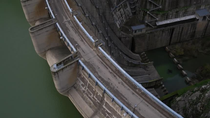 Aerial view flying over a large dam