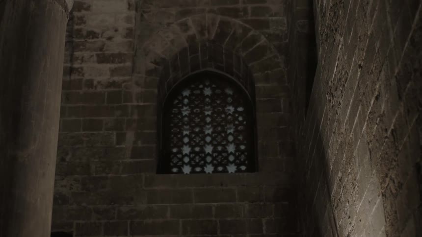 A covering over a window set in a brick wall