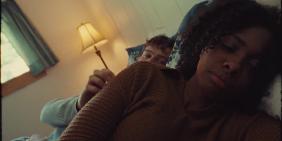 Young couple lying in bed when the man tries to gently touch his girlfriend and she moves away