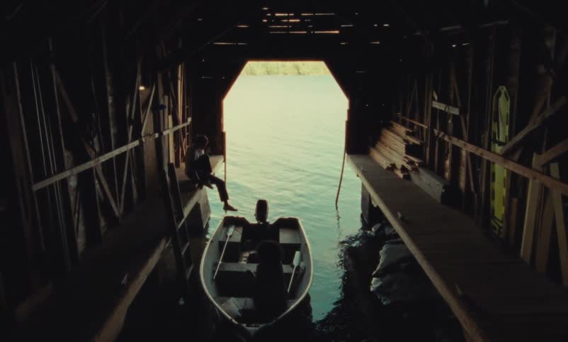 A man unties a boat and climbs in to it