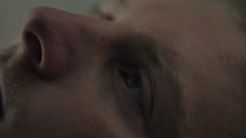 A man opening his eyes and waking up