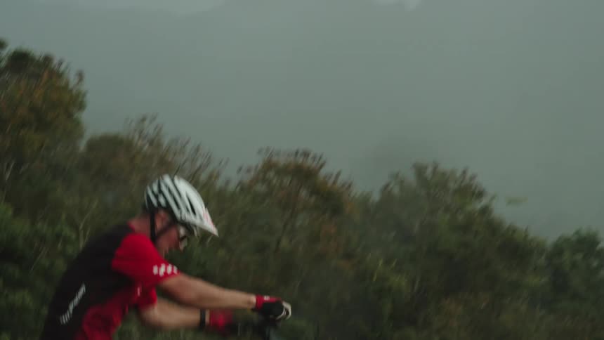 A person is riding a bike in a wooded area