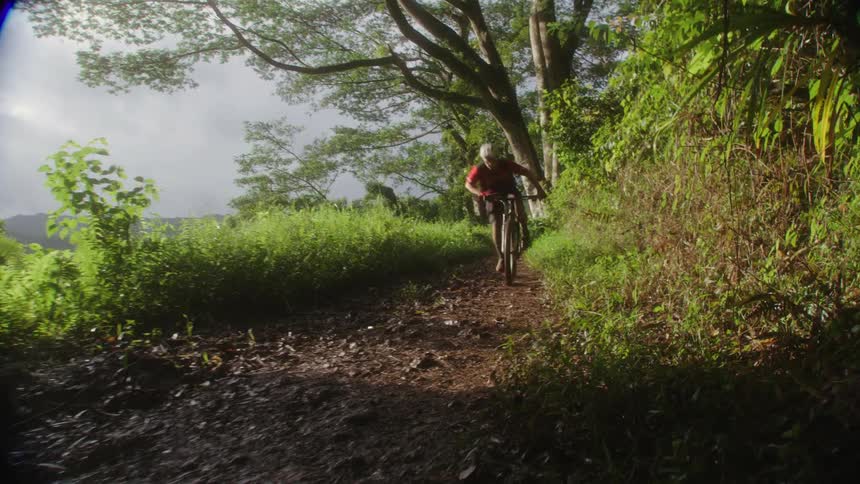 A man riding a mountain bike on a dirt trail