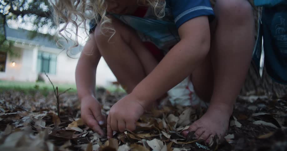 A young toddler is playing outside in the middle of the day time