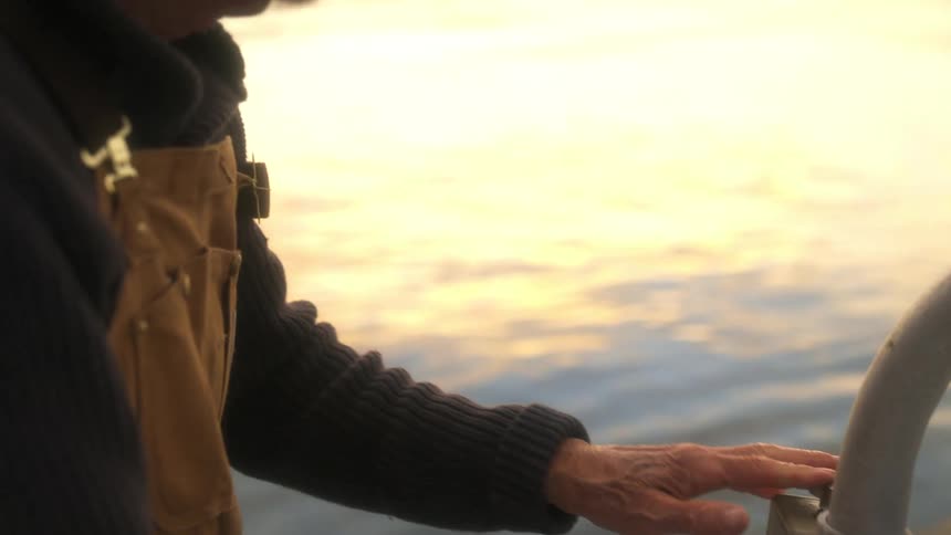 A man pulls the rope on the boat