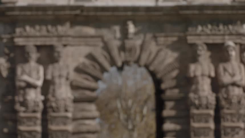 A stone archway is covered with carvings