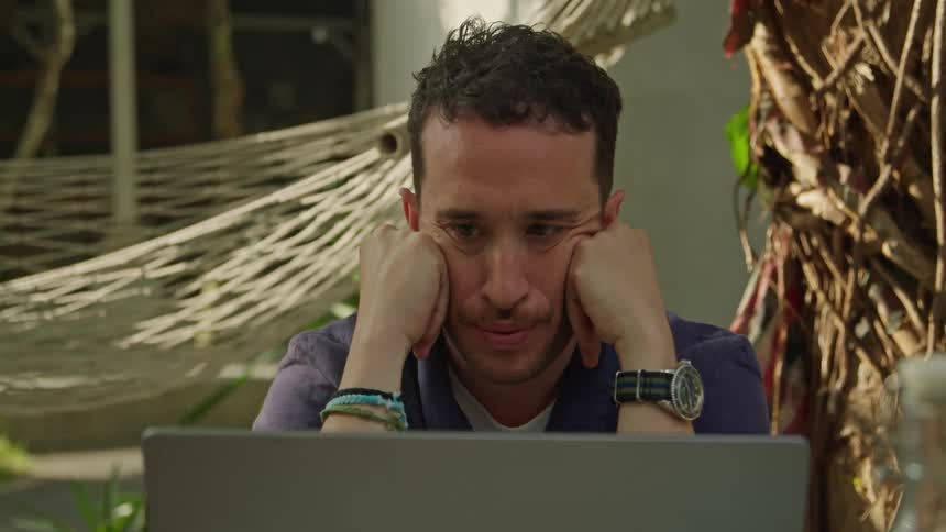 A man is using his laptop outside