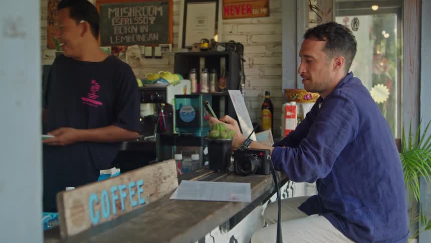 A man drinks coffee in the cafe