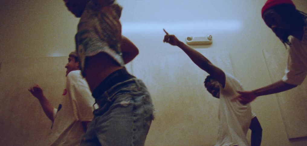 Group of happy people performing a choreographed dance on a room