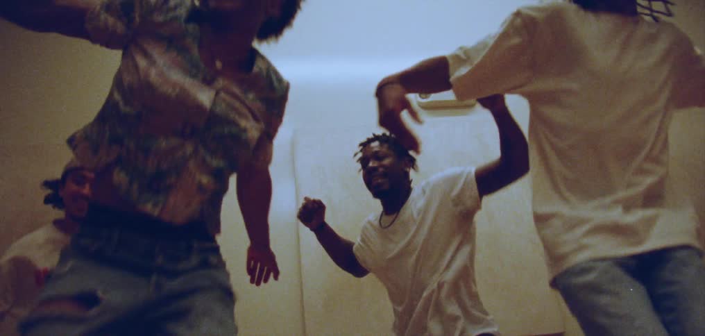 Group of happy people performing a choreographed dance on a room