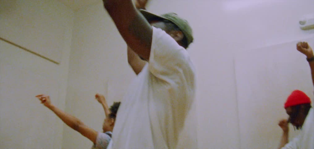 Group of happy people performing a choreographed dance on a room