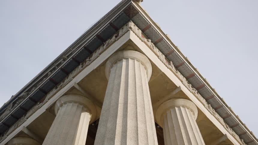 Marble columns and the corner of a capital standing out against the sky