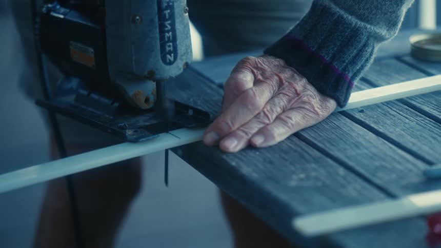 A person cutting a piece of plastic