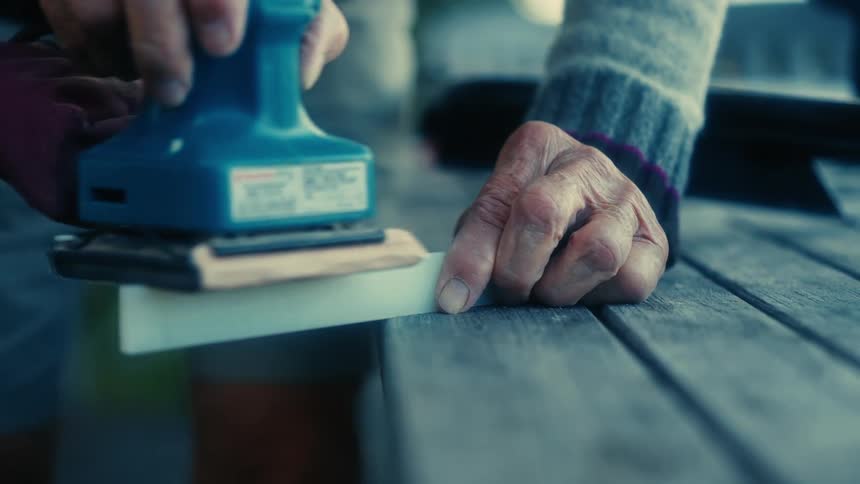 A person is using an electric sander