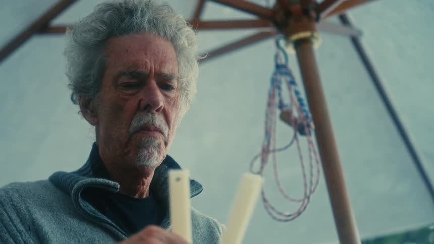 A man looks puzzled at an object