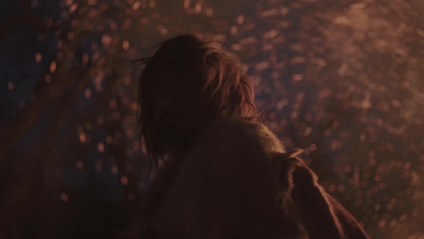 Sparks and flames are flare behind a man wearing animal hides