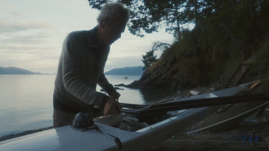 A man is working on his canoe