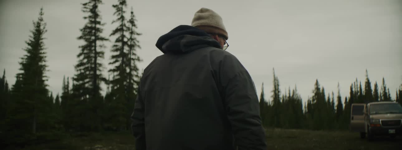 A man is walking towards his van