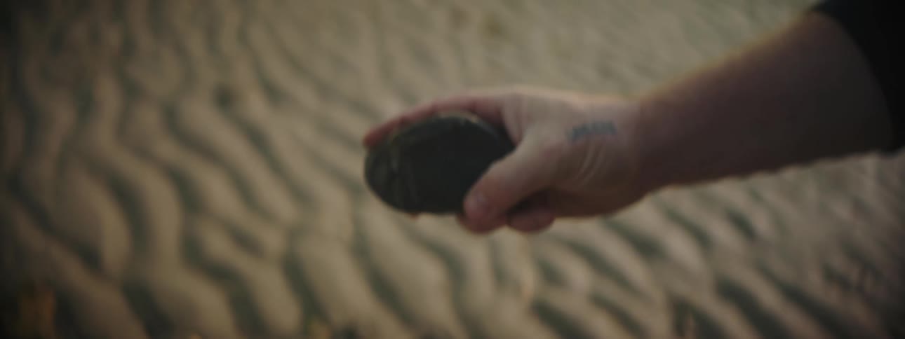 A man looking at a rock