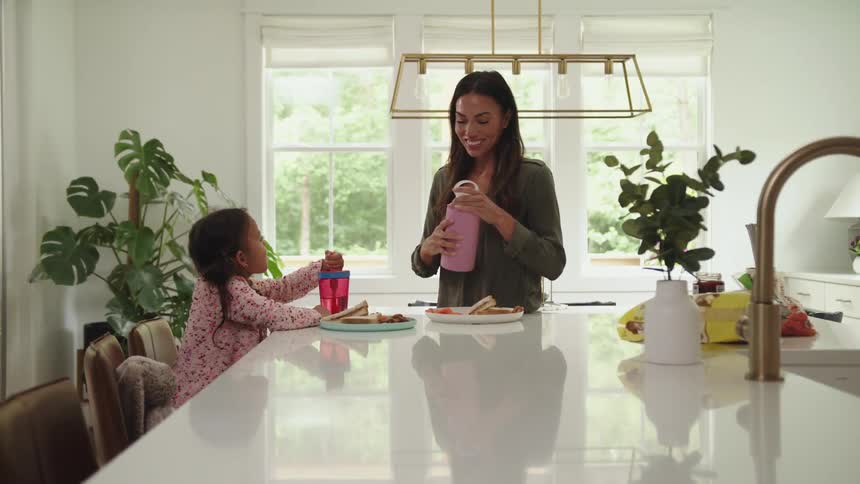 A mother and daughter are eating lunch together