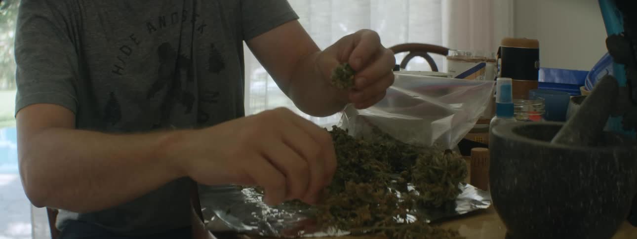 A man breaking up drugs