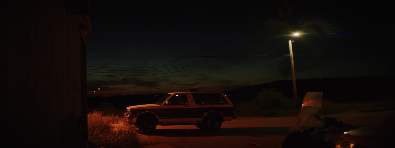 Parked car with allwheel drive suv at night