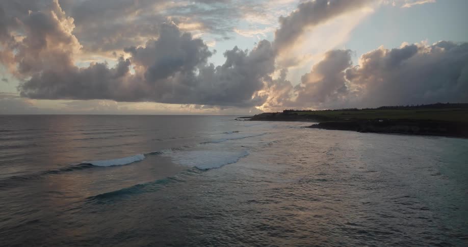 Aerial view of shoreline with highway near the ocean at sunset