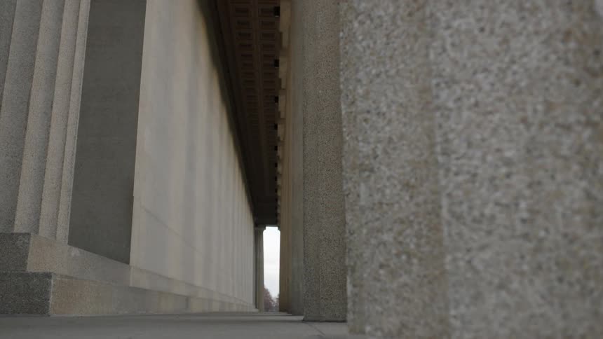 Pillars line the side of this stone building