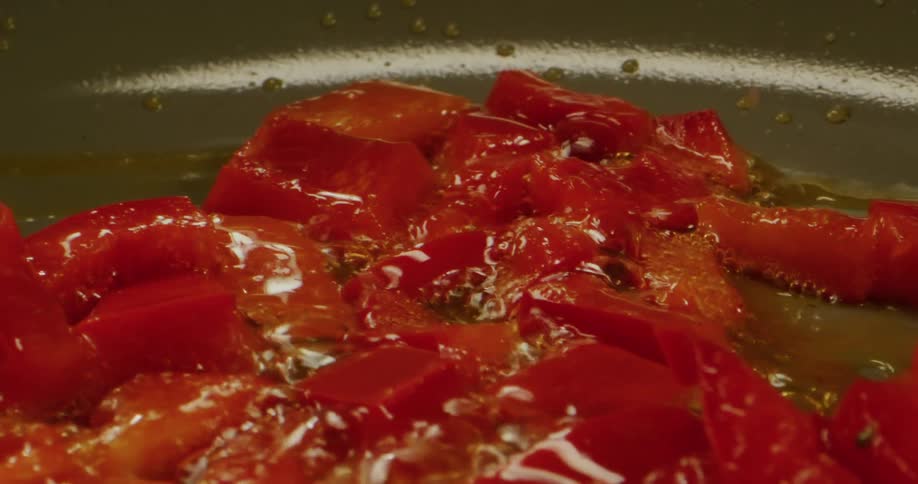 Stir frying vegetables are swirled around pan in oil