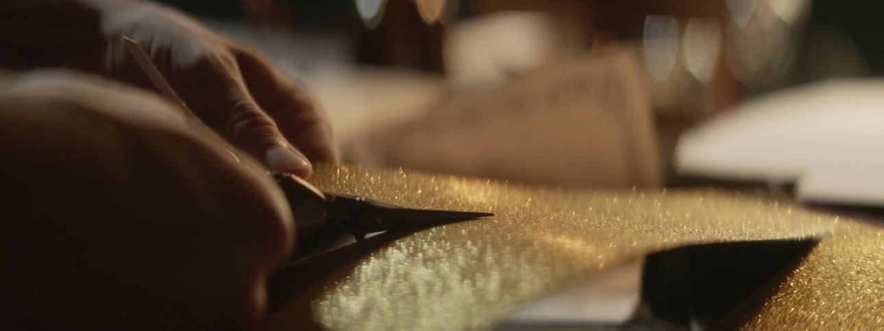 A tailor cuts a piece of fabric
