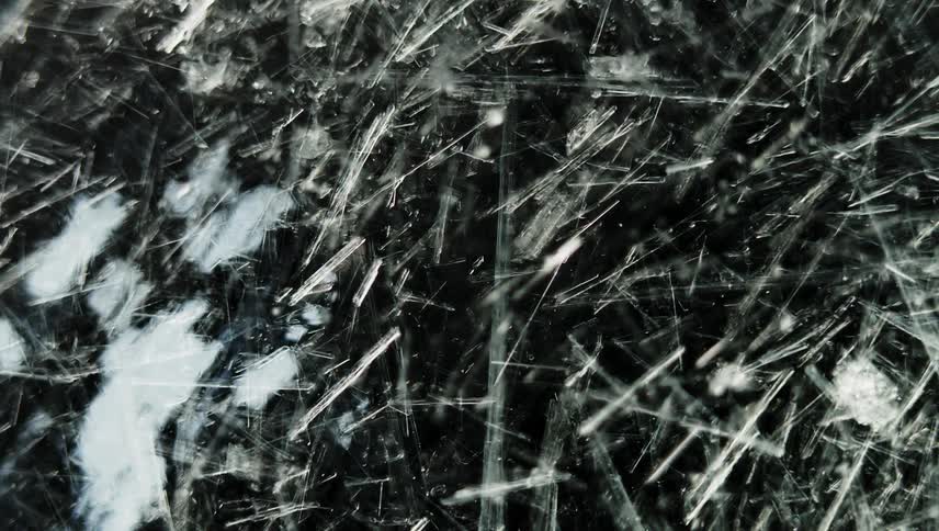 Thin white lines grow and multiply as they move across the darkness