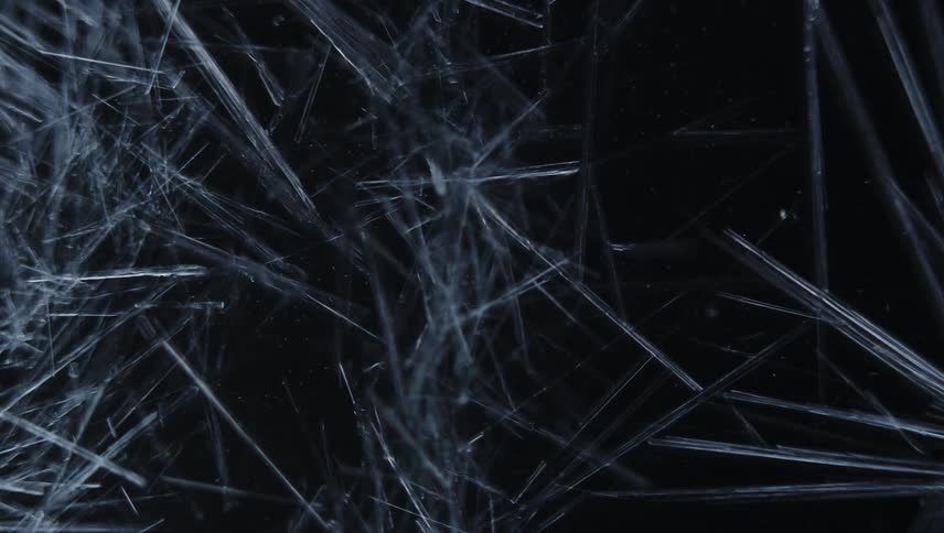 Ice crystals form on black background