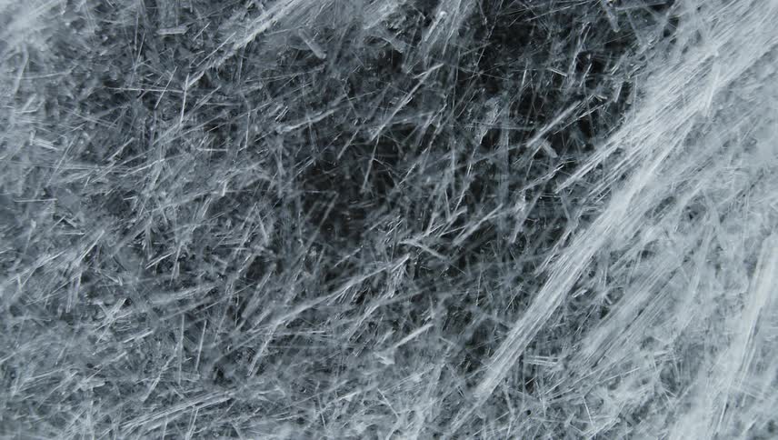 Time lapse close up of of sharp thin ice crystals forming