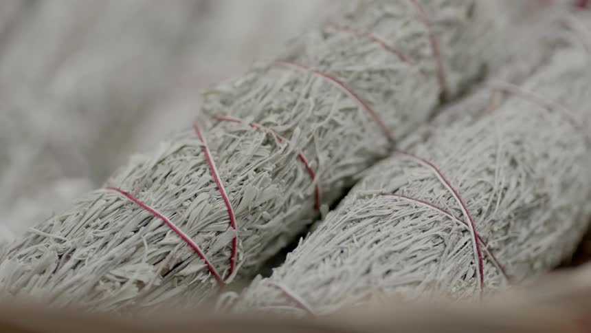Bundles of herbs leaves wrapped in red twine