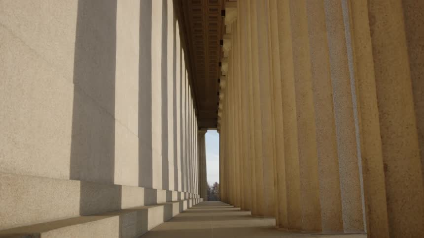 Pillars cast shadows on a wall