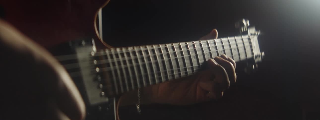 A man plays the guitar on stage