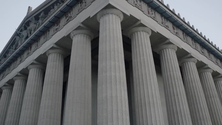 An ornately carved roof is held up by many columns