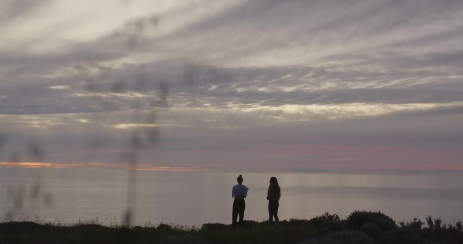 Two women watch the sunset
