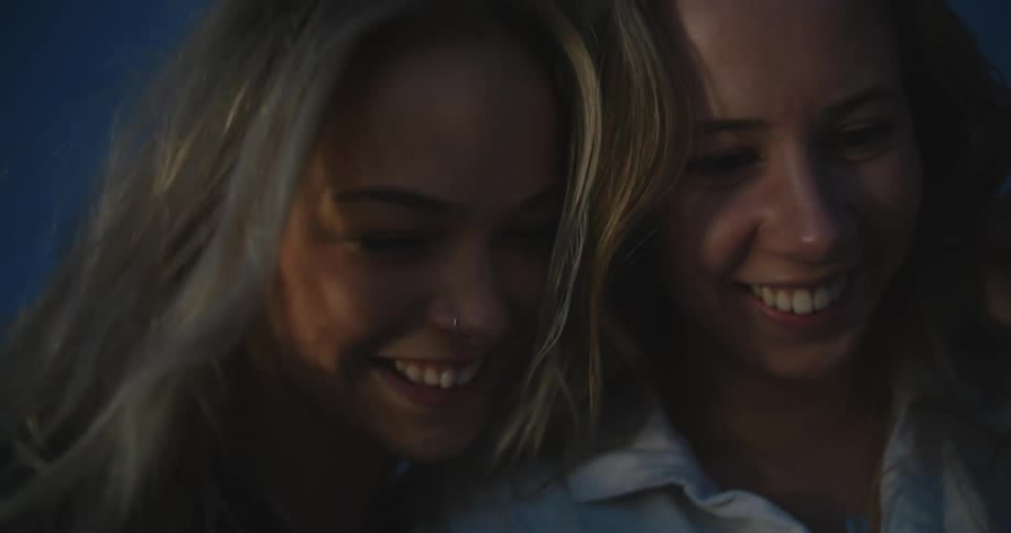 Two women laugh together