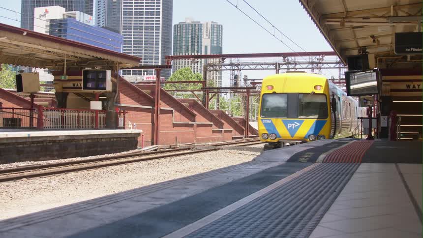 A train is driving through a downtown city